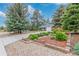 View of charming home with stone accents and a well-manicured front yard featuring rock landscaping and a garden at 881 S Pearl St, Elizabeth, CO 80107