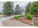View of charming home with stone accents and a well-manicured front yard featuring rock landscaping and a garden at 881 S Pearl St, Elizabeth, CO 80107