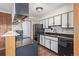 Well-lit kitchen with black appliances, light countertops, and stylish white cabinetry at 881 S Pearl St, Elizabeth, CO 80107