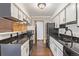 Modern kitchen featuring sleek black appliances, white cabinets, and ample counter space at 881 S Pearl St, Elizabeth, CO 80107