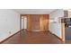 Spacious living room with hardwood floors, brick accent walls, and seamless kitchen access at 881 S Pearl St, Elizabeth, CO 80107