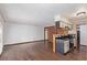 Open-concept living room with hardwood floors seamlessly connecting to the kitchen area at 881 S Pearl St, Elizabeth, CO 80107
