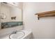 A simple half bathroom featuring a white vanity and sink with mirror and overhead lighting at 12661 W Alameda Dr, Lakewood, CO 80228