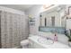 Bright bathroom with a patterned shower curtain and a clean white sink and toilet at 12661 W Alameda Dr, Lakewood, CO 80228