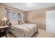 Bedroom with inviting bed, neutral walls, and carpeted floor, well lit by natural light at 12661 W Alameda Dr, Lakewood, CO 80228