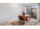 A dining room area with a round wooden table, chairs, and sliding glass door to the patio at 12661 W Alameda Dr, Lakewood, CO 80228