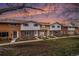 Charming townhomes boast brick and siding exteriors, plus well-manicured front lawns at sunset at 12661 W Alameda Dr, Lakewood, CO 80228