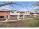 A row of brick and painted townhomes with small front yards and walkways on a partly cloudy day at 12661 W Alameda Dr, Lakewood, CO 80228