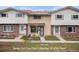 Charming townhome featuring a brick facade and well-maintained front yard at 12661 W Alameda Dr, Lakewood, CO 80228