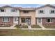 Charming townhome featuring a brick facade and covered front porch, complimented by an inviting landscaped yard at 12661 W Alameda Dr, Lakewood, CO 80228