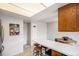 An eat-in kitchen with wood cabinets, a breakfast bar, and white countertops at 12661 W Alameda Dr, Lakewood, CO 80228