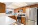 A bright kitchen features stainless steel appliances, lots of counter space, and wood cabinets at 12661 W Alameda Dr, Lakewood, CO 80228