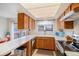 A kitchen with wood cabinets, stainless steel appliances, and a sliding door to the backyard at 12661 W Alameda Dr, Lakewood, CO 80228
