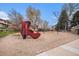 Community playground featuring a large boot-shaped play structure and traditional swings at 12661 W Alameda Dr, Lakewood, CO 80228