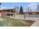 Community pool, fenced for safety, surrounded by well-maintained grassy areas and residential buildings at 12661 W Alameda Dr, Lakewood, CO 80228