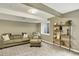 Finished basement area with couch, shelving, decor, and neutral carpeting at 915 S Mckinley Ave, Fort Lupton, CO 80621