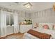 Bedroom featuring a window, light fixture, dresser, and neutral colors at 915 S Mckinley Ave, Fort Lupton, CO 80621