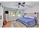 Comfortable bedroom featuring a ceiling fan, large window, and neutral decor at 915 S Mckinley Ave, Fort Lupton, CO 80621