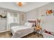Cozy bedroom featuring a decorative light fixture, window, and thoughtfully styled decor at 915 S Mckinley Ave, Fort Lupton, CO 80621