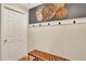 Hallway featuring decorative wall baskets, bench seating, and an entry door at 915 S Mckinley Ave, Fort Lupton, CO 80621