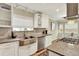 Well-lit kitchen featuring white cabinets, stainless steel appliances, granite countertops, and farmhouse sink at 915 S Mckinley Ave, Fort Lupton, CO 80621