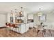 Bright kitchen with white cabinetry, a center island, and a dining area at 915 S Mckinley Ave, Fort Lupton, CO 80621