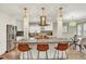 Modern kitchen featuring a center island with bar seating, stainless steel appliances, and stylish lighting at 915 S Mckinley Ave, Fort Lupton, CO 80621