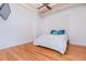 Bright bedroom featuring hardwood floors, a textured accent wall, and a modern ceiling fan at 1555 California St # 605, Denver, CO 80202