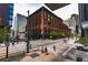Stunning corner building in an urban setting with brick facade and large windows, surrounded by sidewalks and crosswalks at 1555 California St # 605, Denver, CO 80202