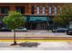 Street view of Residences building with architectural details, mature trees, and street parking at 1555 California St # 605, Denver, CO 80202