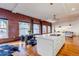 Open concept living space with kitchen island, exposed brick, and modern lighting at 1555 California St # 605, Denver, CO 80202