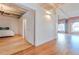 Bright open area with hardwood floors leading to a bedroom and hallway at 1555 California St # 605, Denver, CO 80202