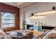 Inviting living room featuring exposed brick, large window, and modern shelving decor at 1555 California St # 605, Denver, CO 80202