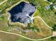 Aerial shot of a park with a gazebo and pier on the pond and walking paths at 7210 Otis Ct, Arvada, CO 80003