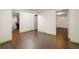 Large basement area with wood-look floors and easy access to a full bathroom at 7210 Otis Ct, Arvada, CO 80003