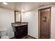 Bathroom features a rustic vanity, new wood look flooring and a tiled shower at 7210 Otis Ct, Arvada, CO 80003
