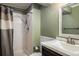 Bathroom features a vanity and a tile shower with a shower curtain and chrome showerhead at 7210 Otis Ct, Arvada, CO 80003