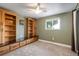 Bedroom with built-in shelving, a ceiling fan, and a window at 7210 Otis Ct, Arvada, CO 80003
