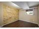 Bedroom features a unique wooden accent wall, neutral paint, and a window for natural light at 7210 Otis Ct, Arvada, CO 80003