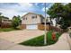 Exterior of a two-story home featuring a large driveway, two-car garage, and wood privacy fence at 7210 Otis Ct, Arvada, CO 80003