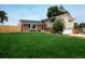 Charming home boasts a well-manicured lawn and inviting curb appeal at 7210 Otis Ct, Arvada, CO 80003