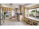 Well-lit kitchen with tiled floors, plenty of storage and natural light at 7210 Otis Ct, Arvada, CO 80003