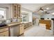Inviting kitchen with tiled floors, built in eating nook, and skylights at 7210 Otis Ct, Arvada, CO 80003