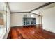 Spacious living room features a built-in bookshelf and sleek hardwood flooring at 7210 Otis Ct, Arvada, CO 80003