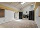 Bright living room with vaulted ceilings, fireplace, and sliding glass doors at 7210 Otis Ct, Arvada, CO 80003