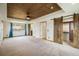 Main bedroom with decorative ceiling, sliding barn door closet, and ensuite bathroom access at 7210 Otis Ct, Arvada, CO 80003
