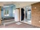 A patio featuring a tiled floor, brick wall, and access to a spa room with hot tub at 7210 Otis Ct, Arvada, CO 80003
