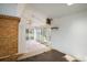 Sun room featuring a brick wall, ceiling fan, and sliding glass doors to the backyard at 7210 Otis Ct, Arvada, CO 80003