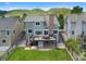 Aerial view of the backyard with a deck, patio, and lush green lawn at 42 Blue Sage, Littleton, CO 80127