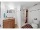 Bright bathroom featuring a shower with updated fixtures and a vanity with storage at 42 Blue Sage, Littleton, CO 80127